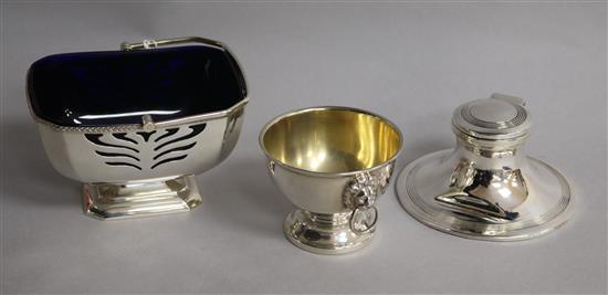 A late 1960s silver sugar basket with liner, a silver capstan inkwell and a small silver bowl with ring handles,